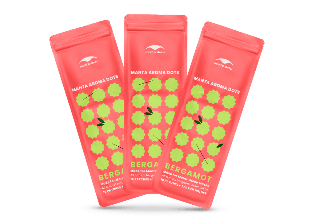 Three coral-red Manta Aroma Dots packets for the Bergamot variant arranged in a fan shape, isolated on a clean white background.