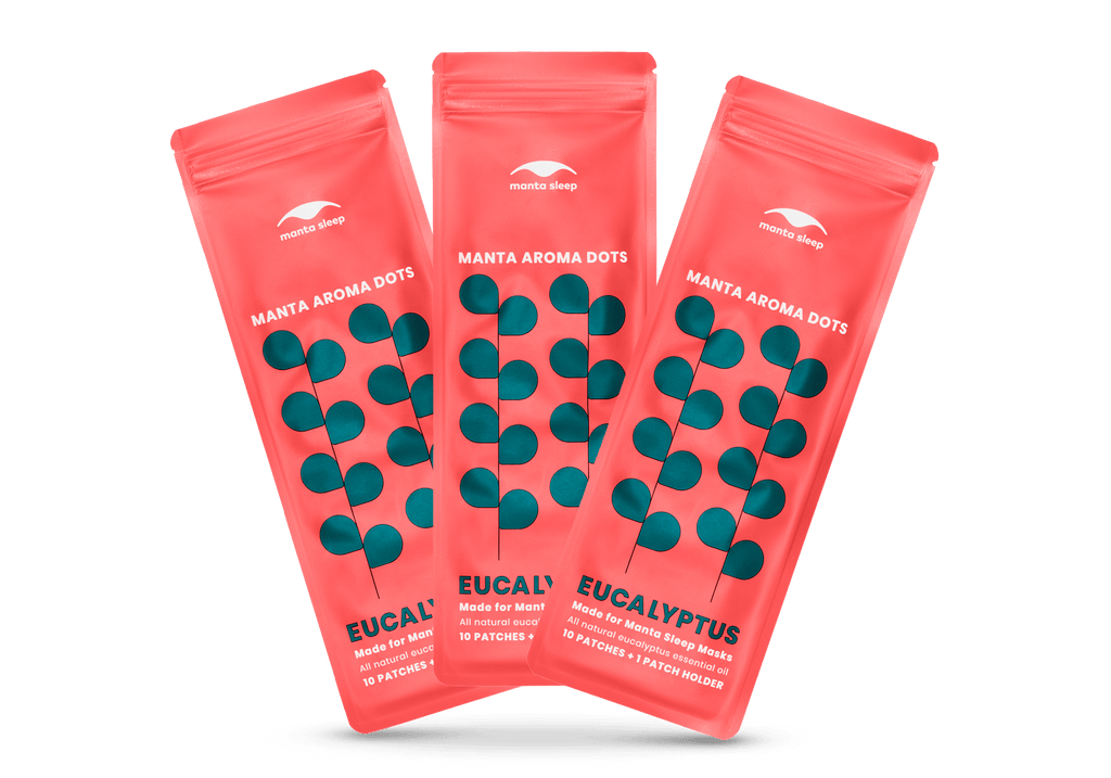 Three coral-red Manta Aroma Dots packets for the Eucalyptus variant arranged in a fan shape, isolated on a clean white background.