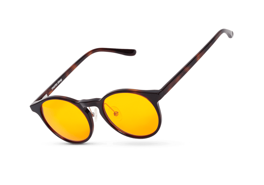 Three-quarter floating studio shot of round tortoiseshell blue light blocking glasses with vibrant yellow lenses, isolated on white.
