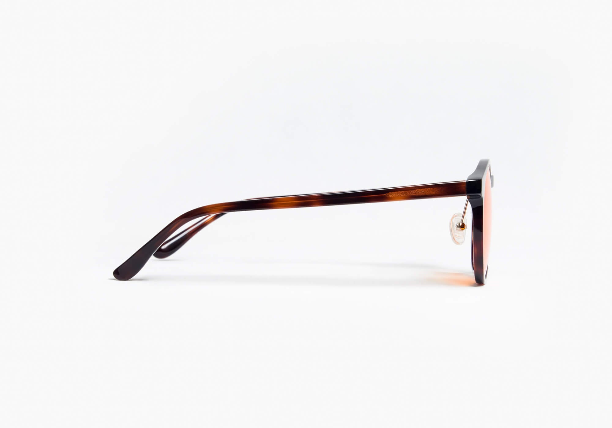 Pure side profile shot of round tortoiseshell glasses with yellow lenses, highlighting the straight temple arm structure on a white background.