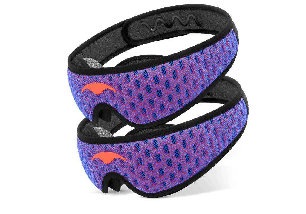 Two Manta Sleep Mask PRO units stacked diagonally, showcasing their blue and red perforated mesh pattern and coral-red Manta Sleep logos.