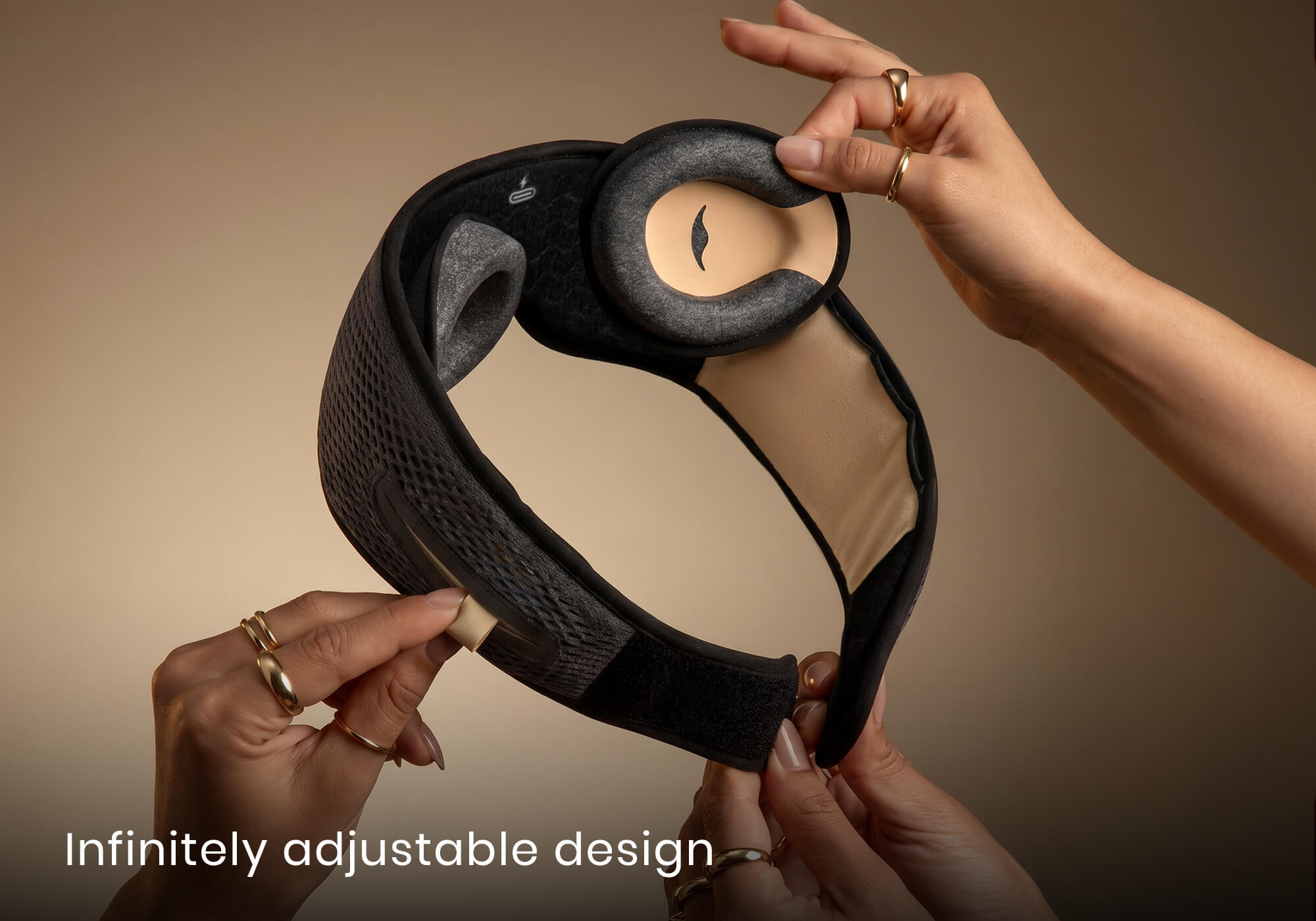 Hands adjusting the modular components and grey eye cups of a grey Manta SOUND mask. Text overlay: "Infinitely adjustable design".