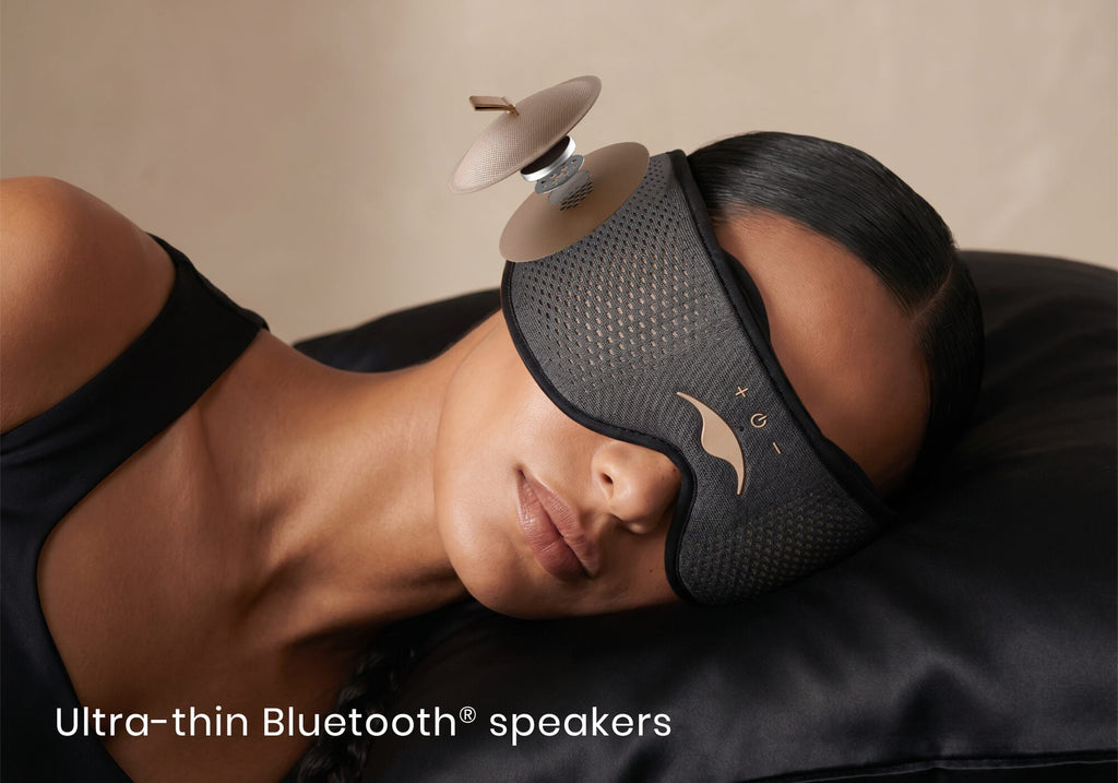 Close-up of a woman lying down wearing a Manta SOUND Sleep Mask, with an exploded diagram overlay of its ultra-thin Bluetooth speaker.