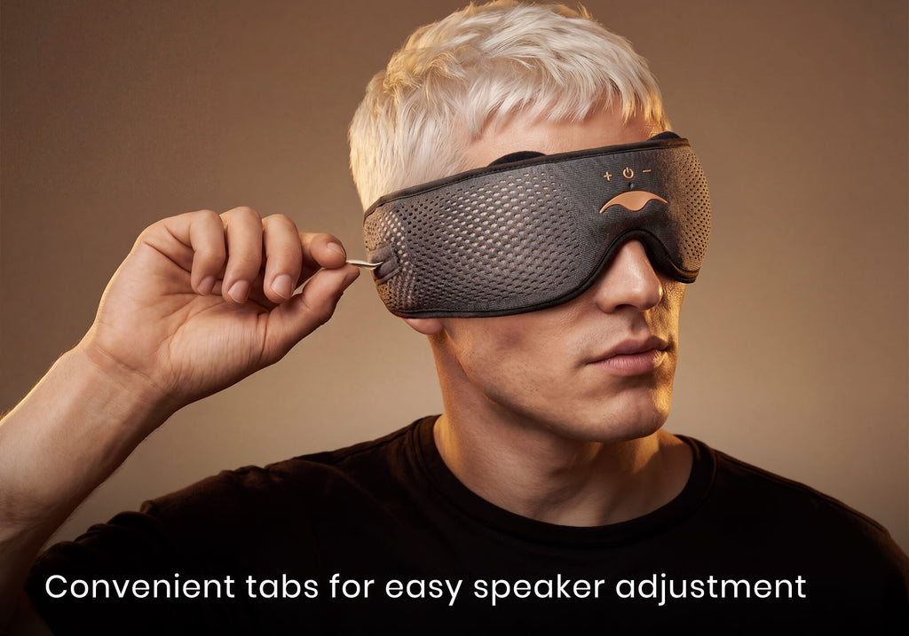 A man wearing the grey Manta SOUND mask adjusts the side speaker using a small tab. Text: "Convenient tabs for easy speaker adjustment".