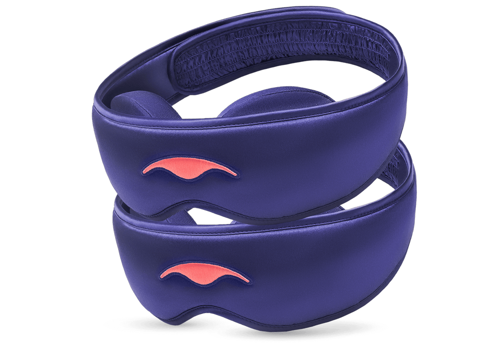 Two purple Manta Sleep Mask SILK units stacked diagonally, showcasing their lustrous texture and coral embroidered Manta Sleep logos.