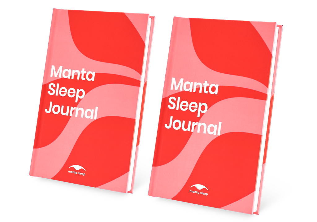 Two Manta Sleep Journals with red and pink wavy covers standing side-by-side, isolated on a white background.
