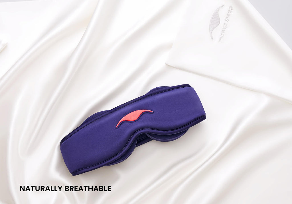 Purple Manta SILK Sleep Mask on top of a pearl white Manta Silk Pillowcase, captioned: "Naturally breathable".