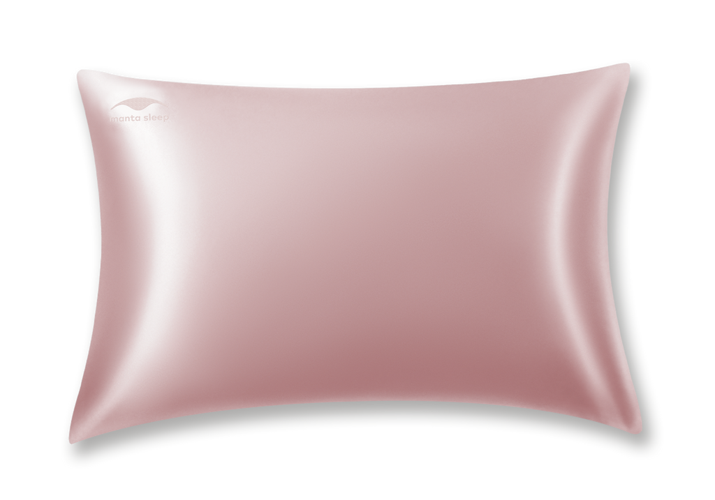 Studio shot of a single standard rose pink Manta Sleep silk pillowcase with a subtle Manta Sleep logo on the top left corner, isolated on white.