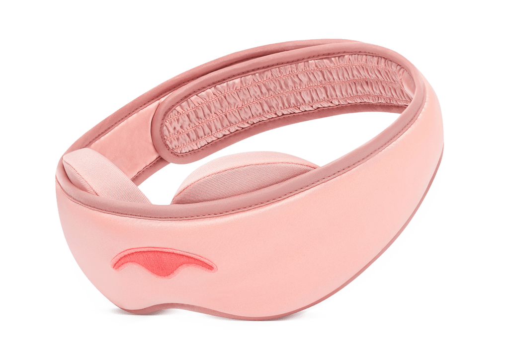 Three-quarter view of a Sunset Pink Manta SILK Sleep Mask on a white background, showcasing its smooth silk texture and contoured design.