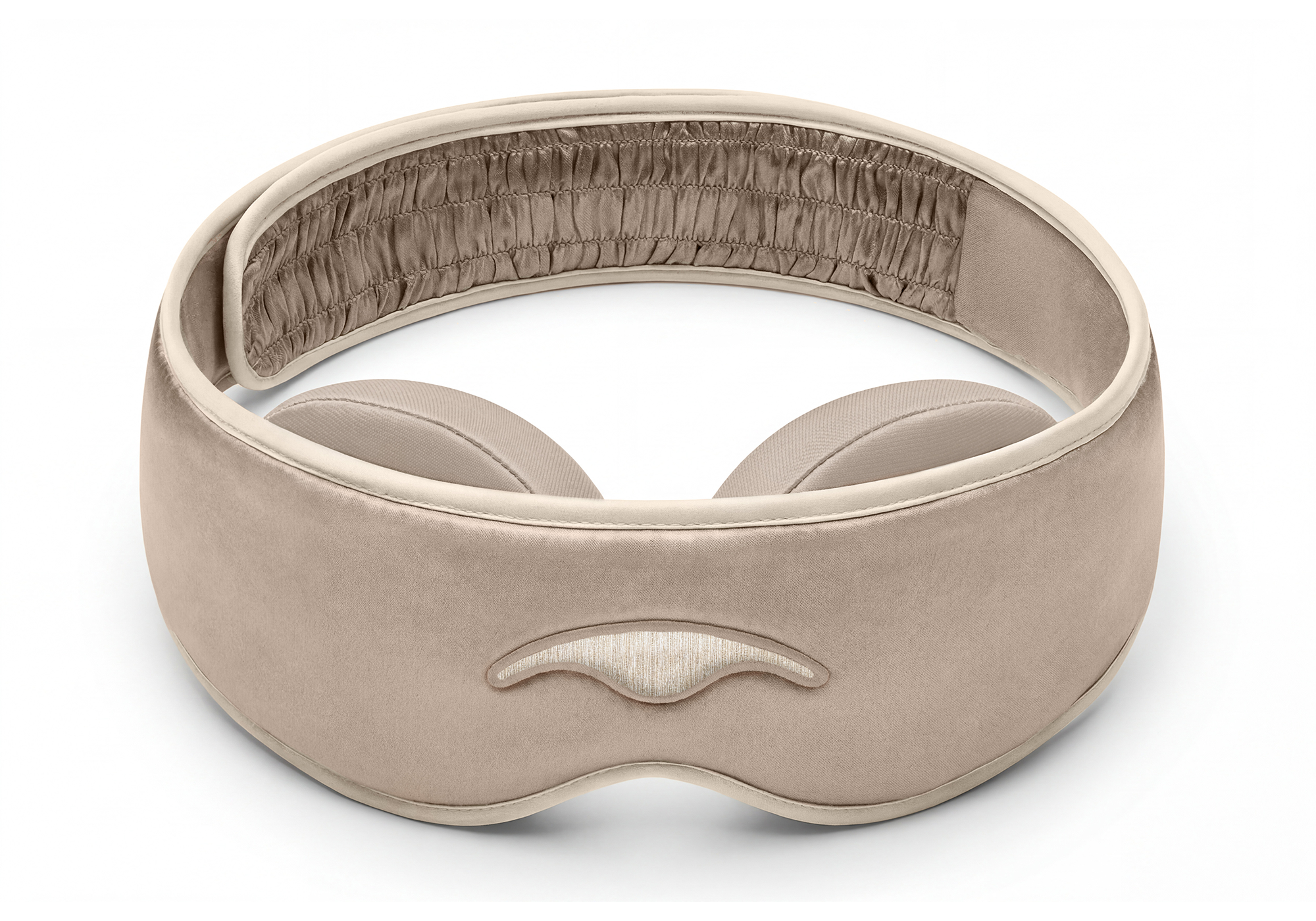 Front-facing studio view of the Tranquil Taupe Manta SILK Sleep Mask, showing its smooth silk texture, ruched inner strap, and beige embroidered logo.