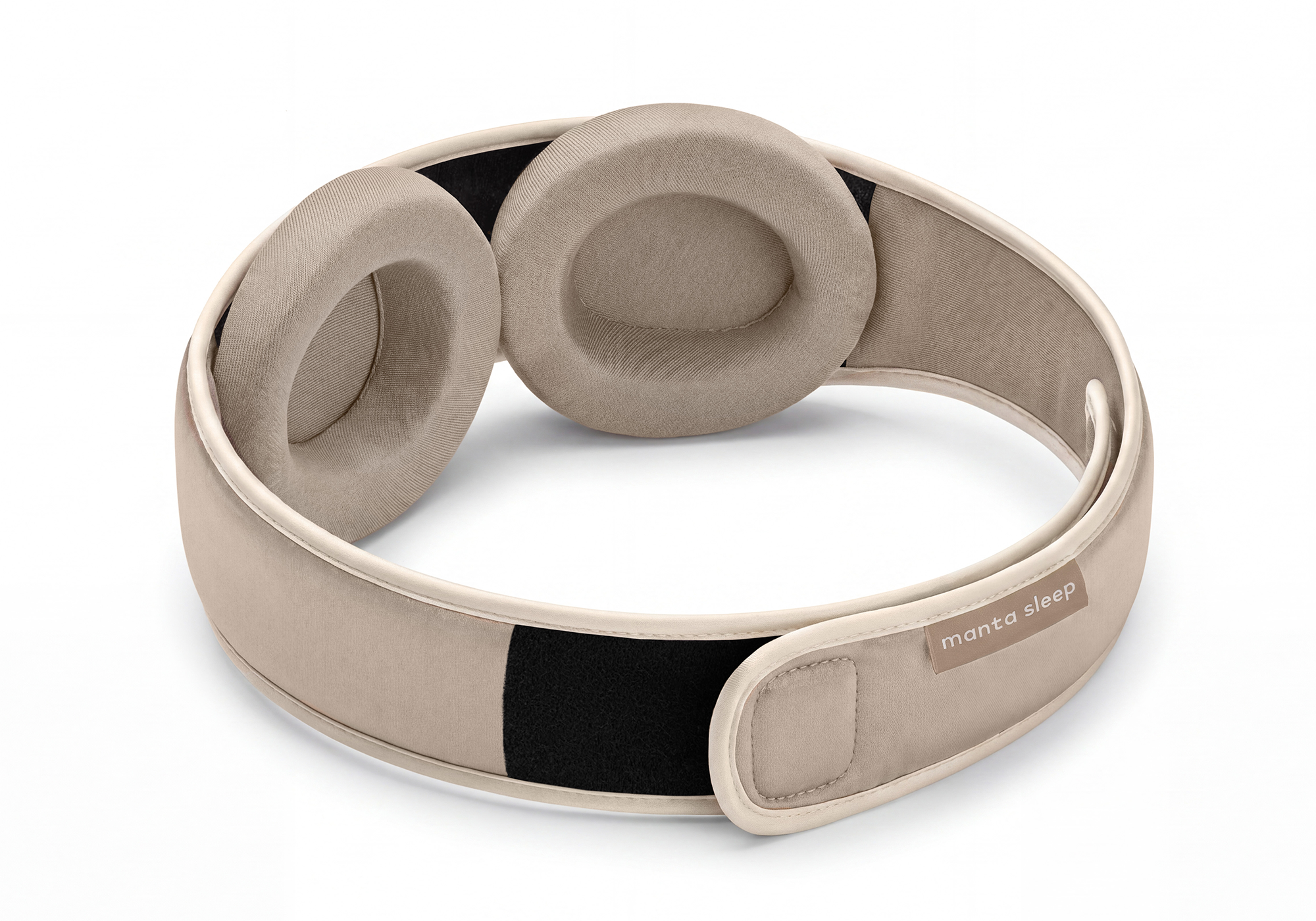Interior view of the Manta Sleep Mask SILK in Tranquil Taupe, displaying the adjustable silk eye cups and a small light brown brand label on the strap.