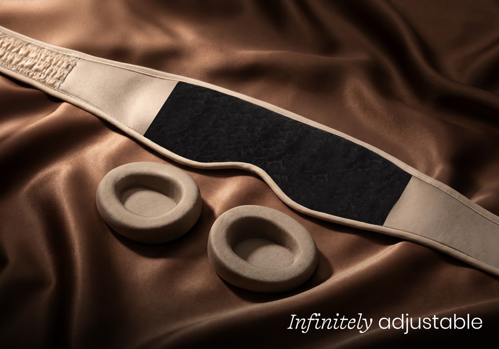 Interior view of a Tranquil Taupe Manta SILK Sleep Mask showing a large fuzzy patch for hook-and-loop fastening of eye cups, captioned "Infinitely adjustable".