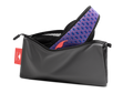 Studio shot of an open, charcoal grey zippered Manta Travel & Laundry Bag with a blue and red Manta PRO Sleep Mask peeking out, isolated on a white background.