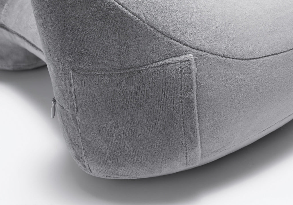 Close-up shot showing the soft fabric texture of a grey plush travel pillow.