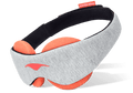 An angled product shot of the Manta STEAM Sleep Mask floating against a crisp white background. The exterior body displays a soft light gray heathered fabric with a coral-pink Manta Sleep logo on the left profile, while the interior reveals thick circular terracotta-orange eye cups designed for heat therapy, attached to a black padded head strap.