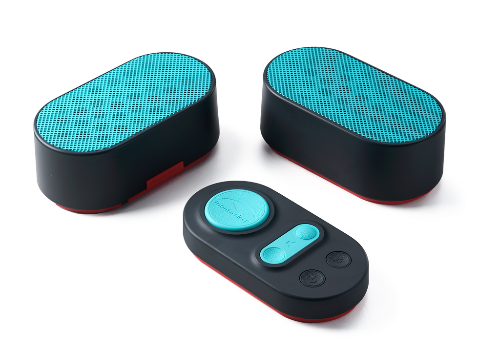 High-angle shot of two oval black white noise speakers with vibrant teal grilles alongside a matching control pad, isolated on a white background.